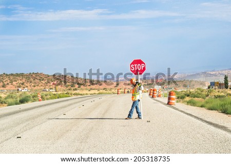 ARIZONA,USA-AUGUST 9,2012:man at work on the arizona\'s route block the traffic for a street work during a sunny day