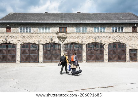 MAUTHAUSEN,AUSTRIA-MAY 10,2014:two people crossing the Mauthausen camp with camera equipment to film a documentary on the Austrian concentration camp during a cloudy day.
