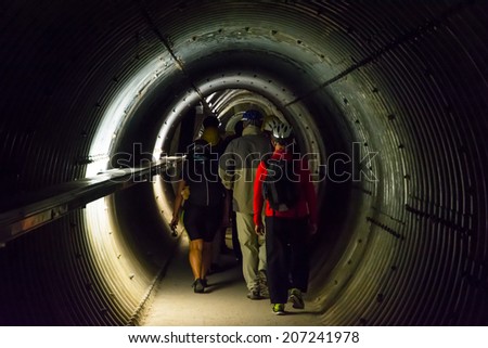 MAUTHAUSEN,AUSTRIA-MAY 10,2014:people with helmet visit the Gusen tunnel,a serie of secret tunnels near the concentration camp of mauthausen used by nazist to built planes in secret