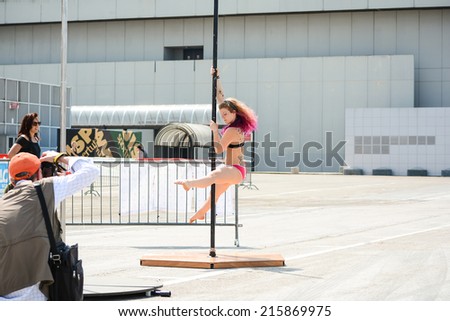 BOLOGNA,ITALY-JUNE 7,2014:Young pole dance woman dance with the pole during a sporting event named \