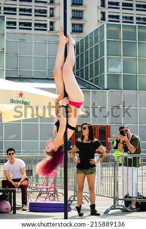 BOLOGNA,ITALY-JUNE 7,2014:Young pole dance woman dance with the pole during a sporting event named \