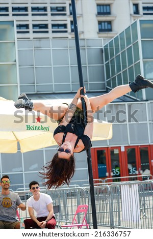 BOLOGNA,ITALY-JUNE 7,2014:Young pole dancer woman with the pole during a sporting event named \