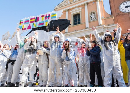 SAN GIOVANNI IN PERSICETO,BOLOGNA,ITALY-MARCH7,2015:funny people in colored carnival costume and masks celebrate at the traditional carnival of san giovanni in persiceto during a sunny day.