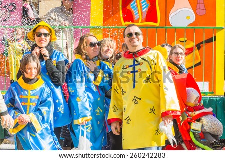 SAN GIOVANNI IN PERSICETO,BOLOGNA-MARCH 7,2015:funny people in colored carnival costume and masks celebrate at the traditional carnival of san giovanni in persiceto during a sunny day.