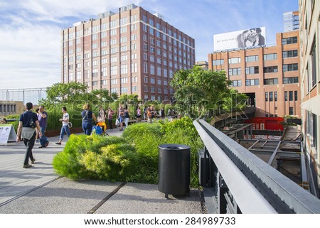 NEW YORK CITY,USA-AUGUST 5,2013:High Line Park visitors at the elevated pedestrian walkway.The High Line is a public park built on an historic freight .