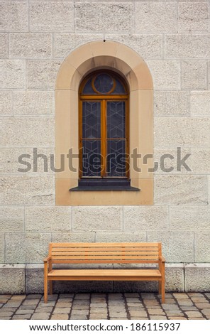 bench in from of old building with window
