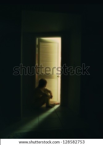 a person sitting outside a bedroom door