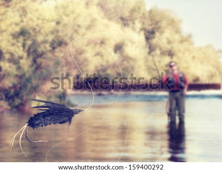 a person fly fishing in a river with a fly in the foreground vintage toned