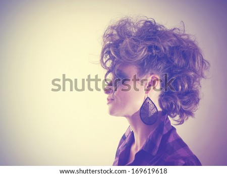 a serious looking woman side profile done with vintage tones for a retro look