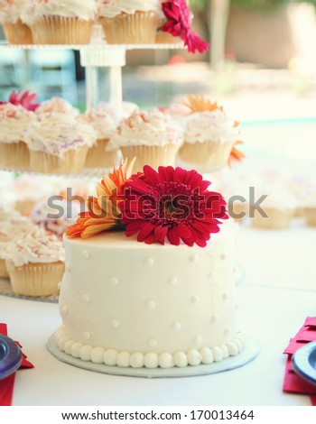 a cake with cupcakes in the background at a wedding party celebration