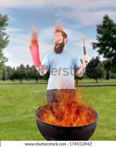 a man grilling with a fire that\'s too big