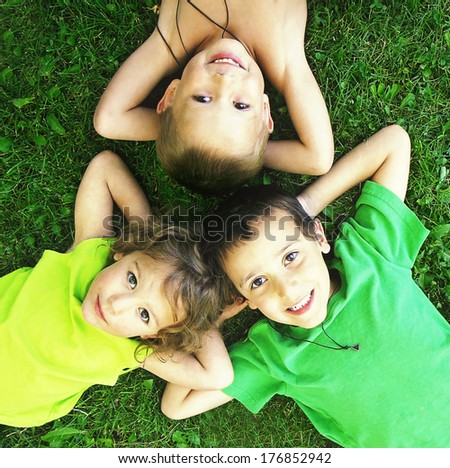 Some Kids Playing In The Grass Together