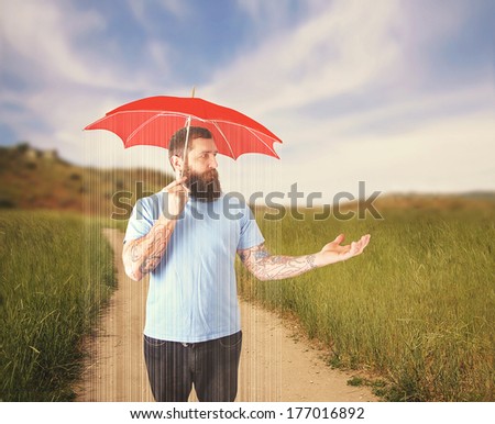 a guy in a thunderstorm under a red umbrella on a clear sunny da