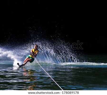 a young woman water skiing on a lake