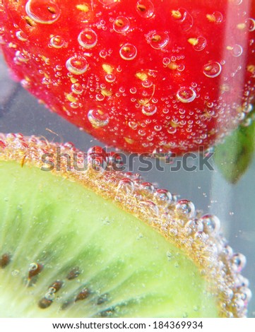a strawberry and kiwi on a cool drink
