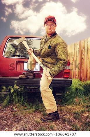 a redneck man with an ax in his hands done with a warm filter