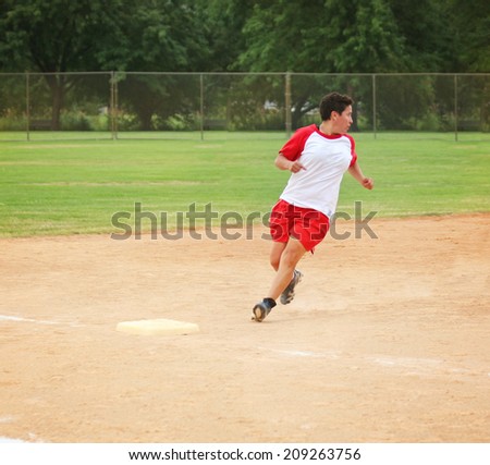 a woman running on a dirt field while playing a softball game