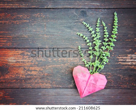 an origami heart on old fence boards - good for valentine\'s day or background design
