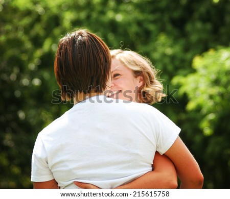 two people hugging outside