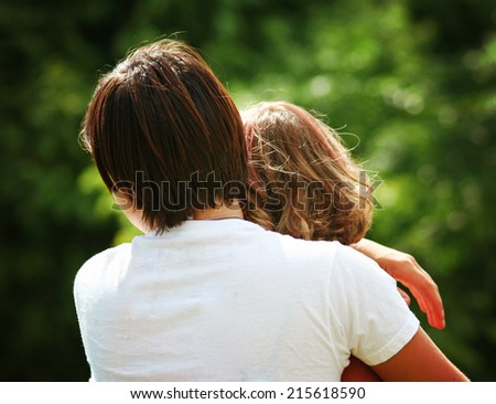 two people hugging outside