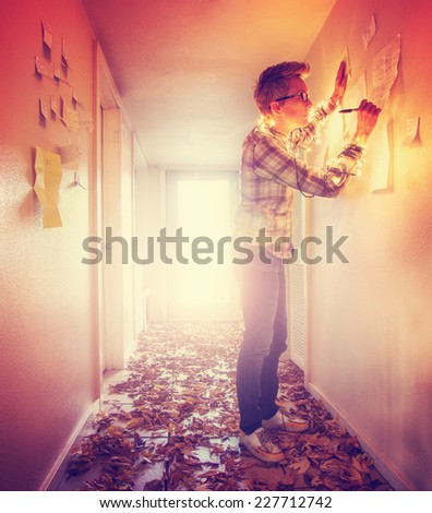 a girl writing on paper notes stuck to a wall in a bright hallway full of leaves that is backlit and toned with a retro vintage instagram filter effect