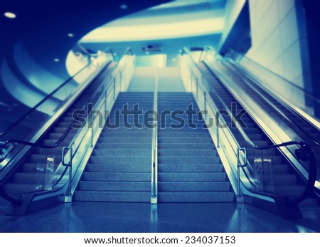 stairs and an escalator at an airport toned with a retro vintage instagram filter effect