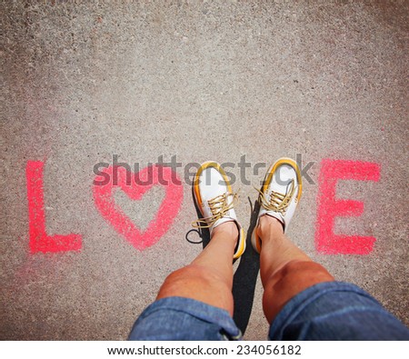 two feet making a sign for the letter V in the word love