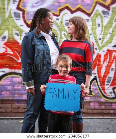 a cute family holding a sign that read family