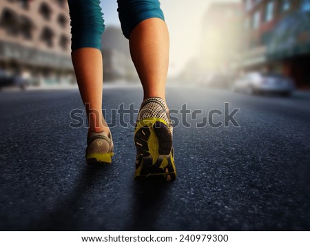 a woman with an athletic pair of legs going for a jog or run during sunrise or sunset - healthy lifestyle concept done with an instagram like filter