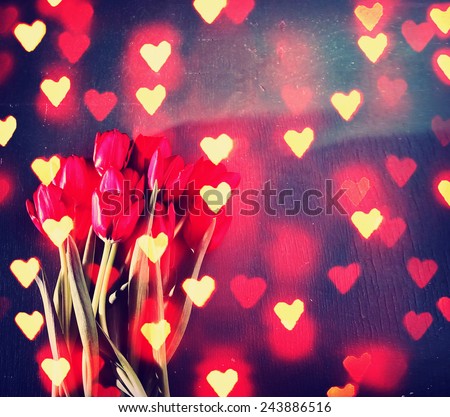 tulips on a wooden board. good for mother\'s day, easter, valentine\'s day or other holidays symbolizing love toned with a retro vintage instagram filter effect