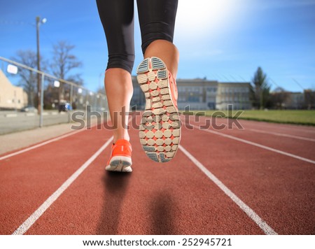a woman with an athletic pair of legs going for a jog or run during sunrise or sunset - healthy lifestyle concept