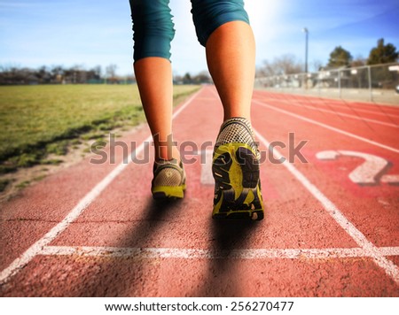 a woman with an athletic pair of legs going for a jog or run during sunrise or sunset - healthy lifestyle concept