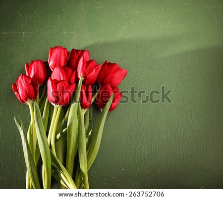 tulips on a wooden board. good for mother's day, easter, valentine's day or other holidays symbolizing love