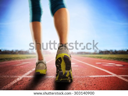 an athletic pair of legs going for a jog or run during sunrise or sunset - healthy lifestyle concept