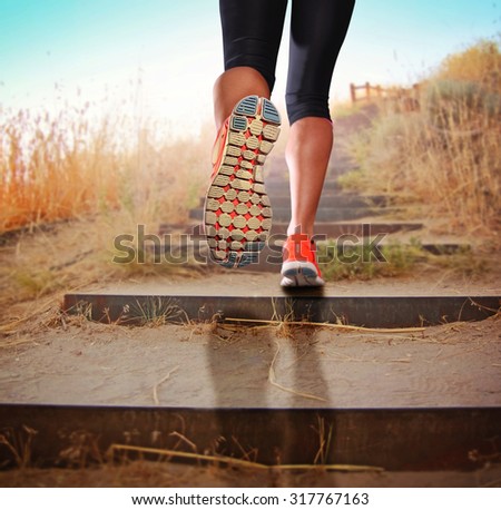 a woman with an athletic pair of legs going for a jog or run during sunrise or sunset up stairs in the mountains - healthy lifestyle concept for urban living