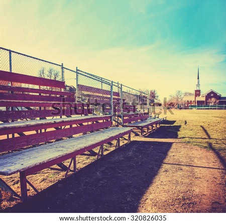 a set of old wooden bleachers for cheering on a sporting event at a local high school toned with a retro vintage instagram filter app or action effect