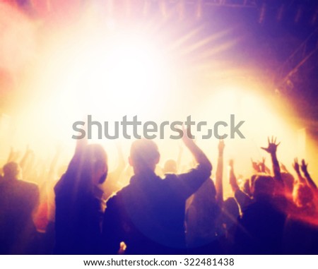 a crowd of people at a concert with a slight blur toned with a retro vintage instagram filter effect app or action