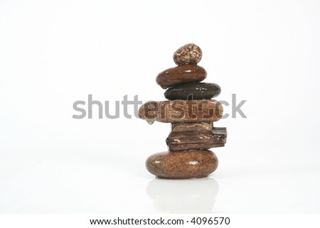 six stones balancing on a white background
