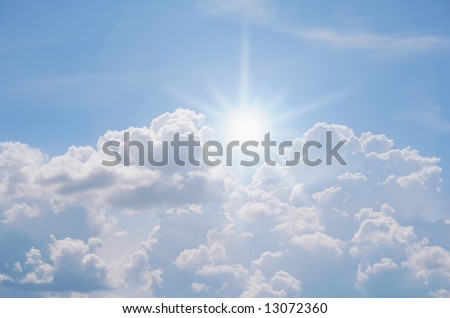 the sun breaking through a cluster of clouds