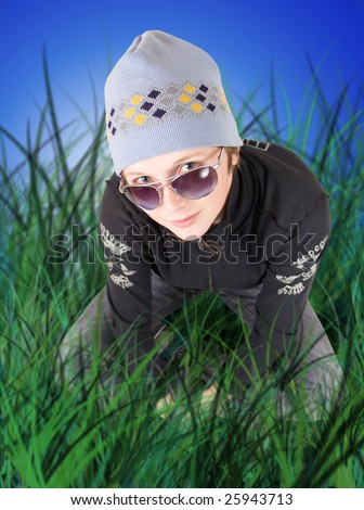 young woman kneeling down in the grass