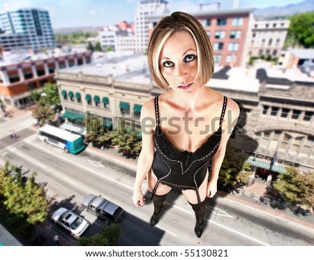 a giant woman in a tiny street scene