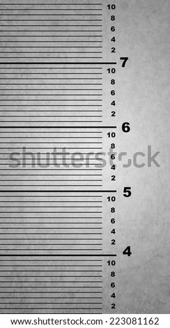 ruler on a wall of a jail to measure people height