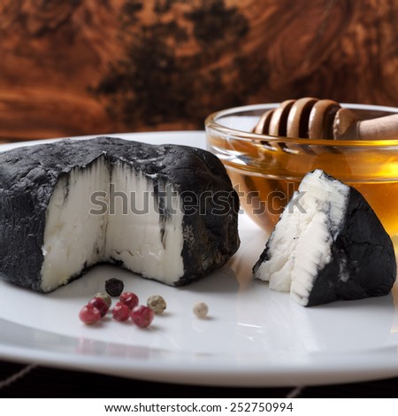 delicious fresh goat cheese covered with black ash and honey
