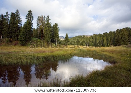 Reflection in smooth water of mountain lakes