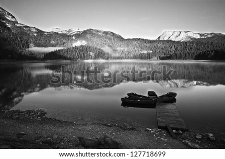 Morning mountain landscape lake and boats black and white