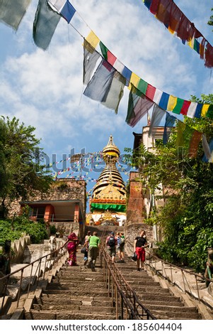 KATHMANDU, NEPAL - SEPTEMBER 30, 2012 - Tourists walk up the stairs to the stupa Swayambunath