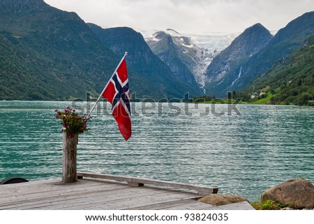 The Norwegian flag against the Norwegian landscape
