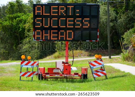 Roadside lighted alert sign that says ALERT: SUCCESS AHEAD because success is close, keep going.