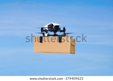 Drone flying through the air with a delivery box package clamped on to deliver to customer