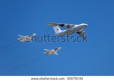 MOSCOW - MAY 9 : Russian Air Force airplanes (four-engined aerial refueling tanker Il-78 and attack aircrafts Su-24) imitate aerial refueling at Moscow Victory Parade May 9, 2009 in Moscow.
